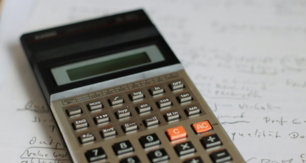 a calculator sitting on top of a piece of paper